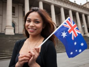 Student holding the Australian flag, exploring options to sponsor student visa for study opportunities in Australia.