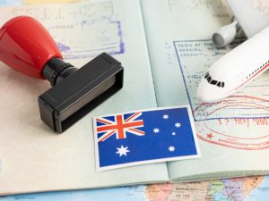 A visa application rejected a stamp, an aeroplane, and the Australian flag symbolising denied entry or immigration challenges in Australia.