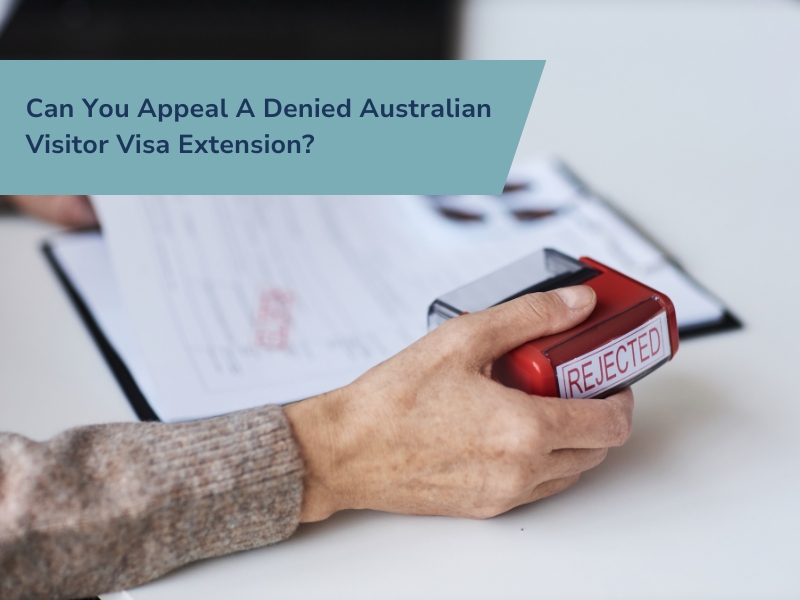 Person holding a rejected stamp, symbolising challenges in applying for an Australian Visitor Visa Extension after refusal.